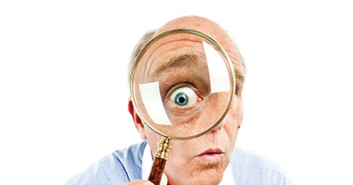 157681704 man looking thru magnifying glass web