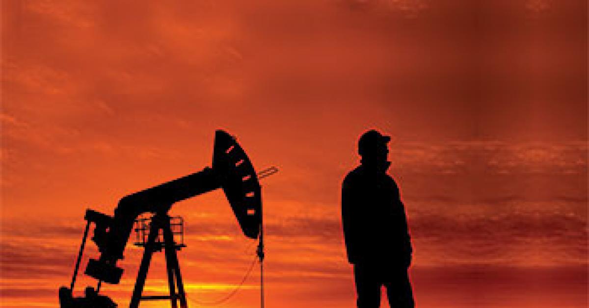Man next to oil well image