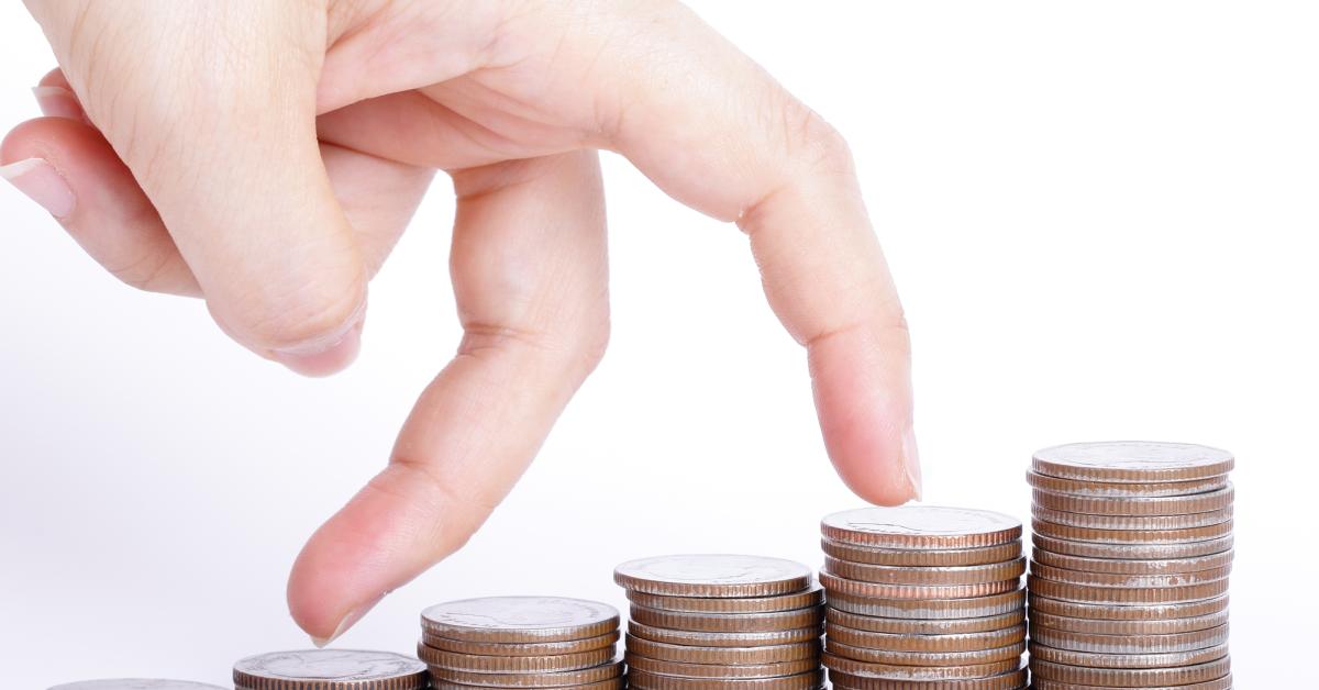 fingers walking on stacks of coins