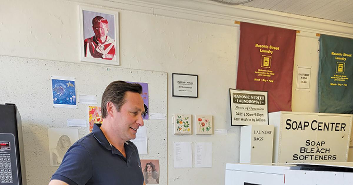 Masonic Street Laundry owner Jason Foster admires art