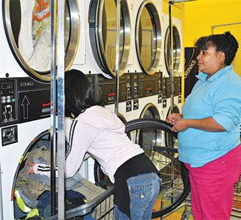Calvary Laundromat family doing laundry
