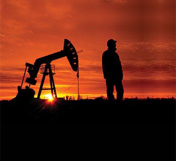 Man next to oil well image